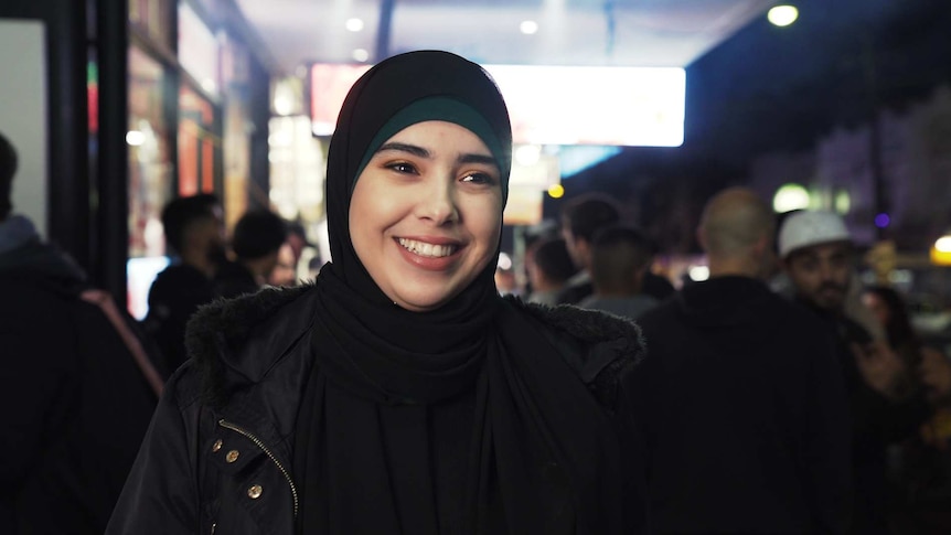 Ryma Tchier smiling at the camera at the Ramadan night market in Lakemba, in Sydney's west.