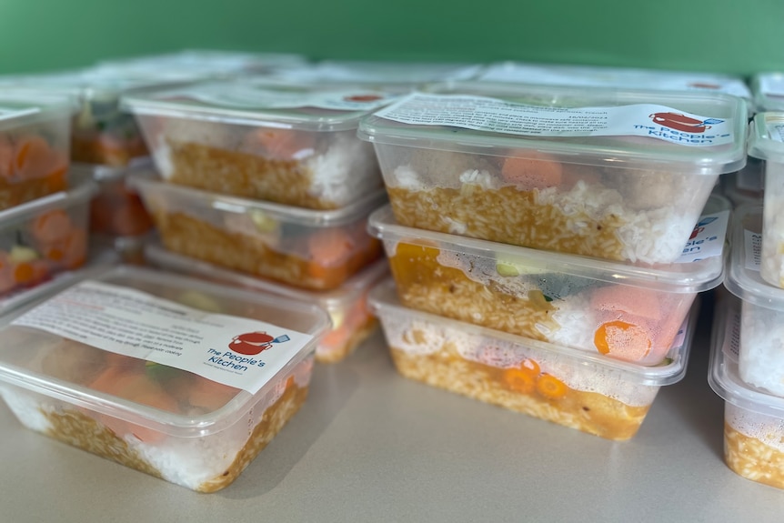 stack of plastic containers with meals