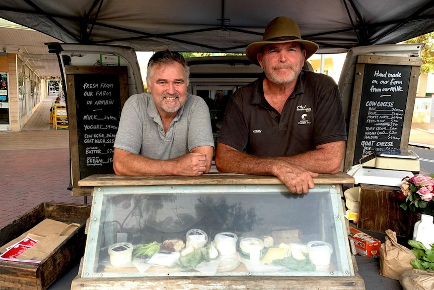 Cheesemakers Paul and Kerry Wilson behind their cheese display at the farmers' market.
