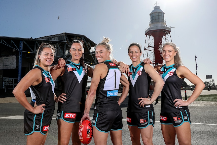 Erin Phillips poses with her back to the camera alongside the rest of the Port Adelaide AFLW leadership group.