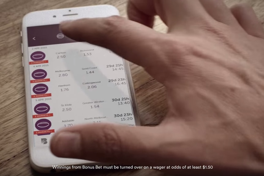 A video advertisement for CrownBet shows a man betting on AFL.