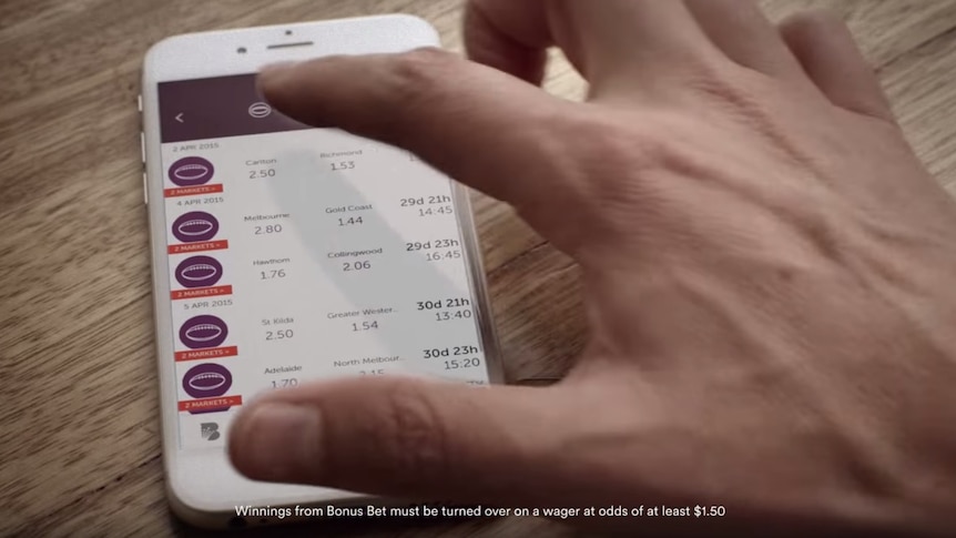 A video advertisement for CrownBet shows a man betting on AFL.