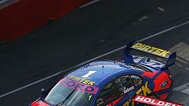 Marcos Ambrose tussles with Mark Skaife