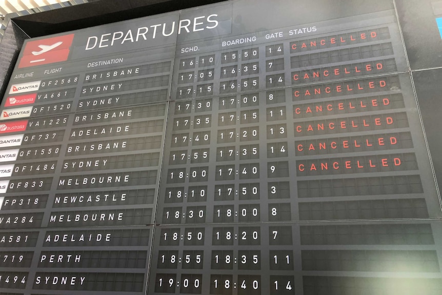 The board advising of flight information shows all flights are cancelled.