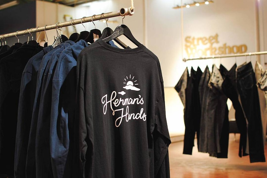 Herman's Hands clothing on racks.