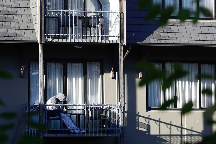 A person looks at a mobile phone on balcony at a hotel in Christchurch.