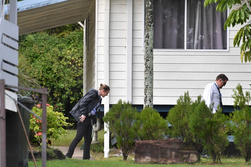 Two detectives search the grounds of the mobile home park at Stapylton.
