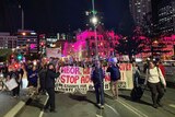 Hundreds of anti-Adani protesters march over Victoria Bridge towards the ABC at South Bank.