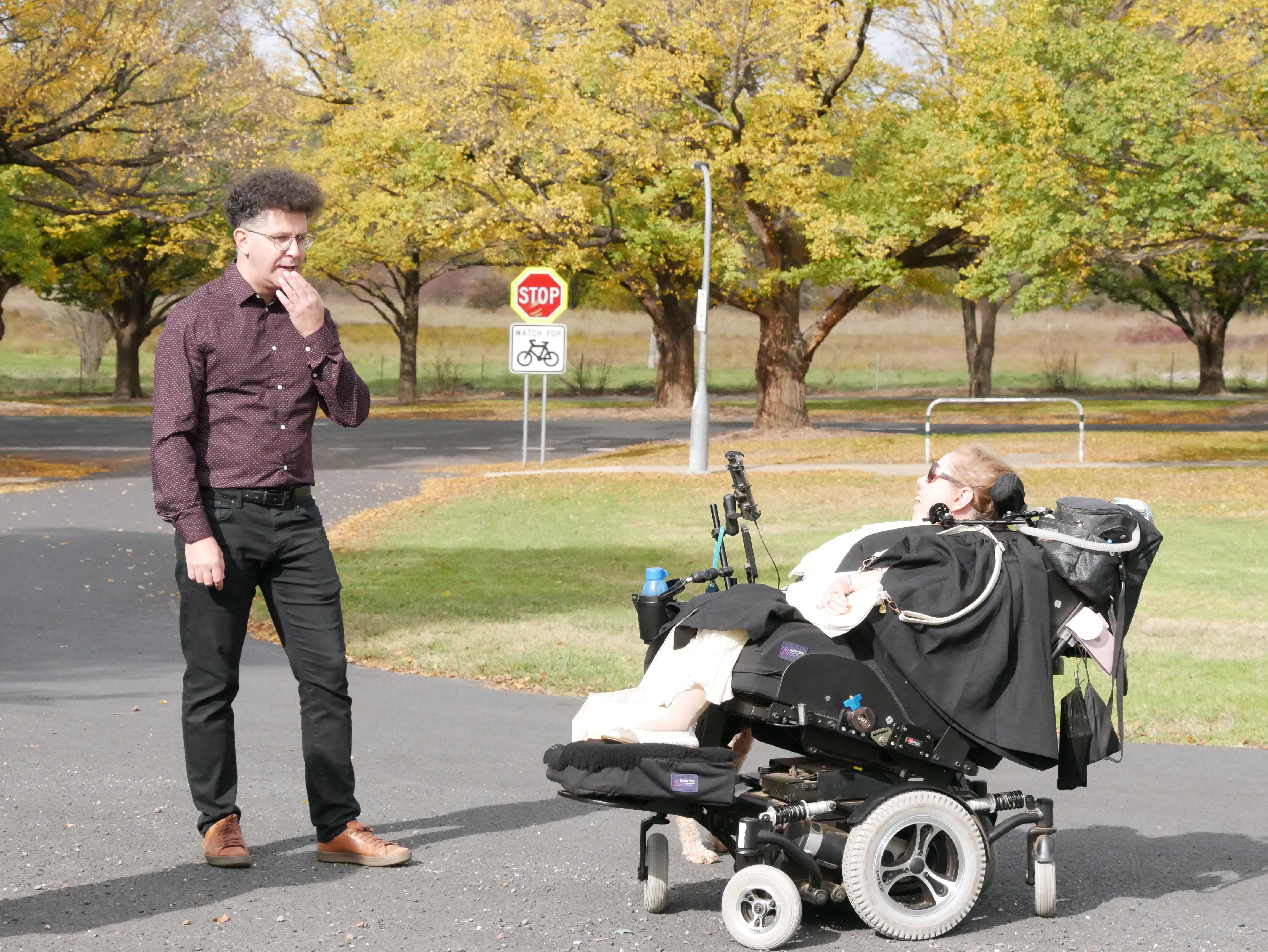 Eleanor speaks with Dr Nicolas Campione with a backdrop of autumn trees in Armidale.