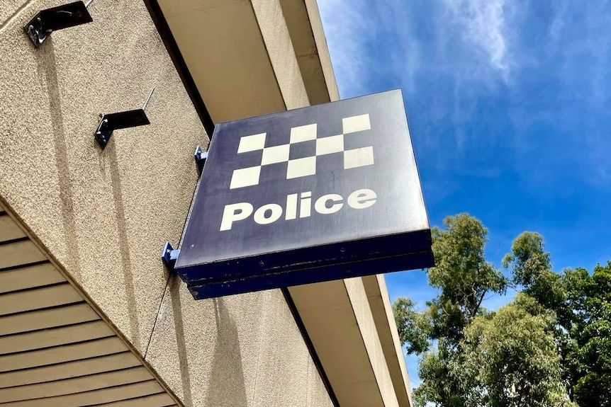 Police blue and white chequered sign