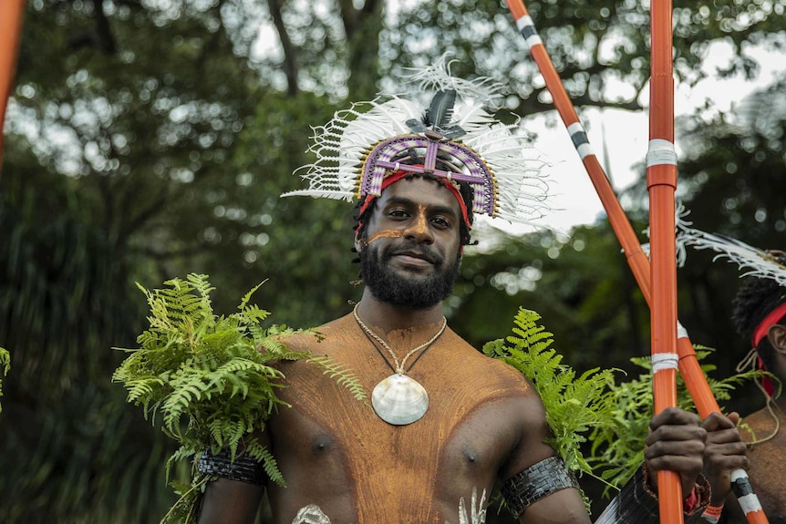 Colour photo of Gubi Kaddy of Meuram Murray Island Dancers standing outdoors and side of stage at Dance Rites 2018.