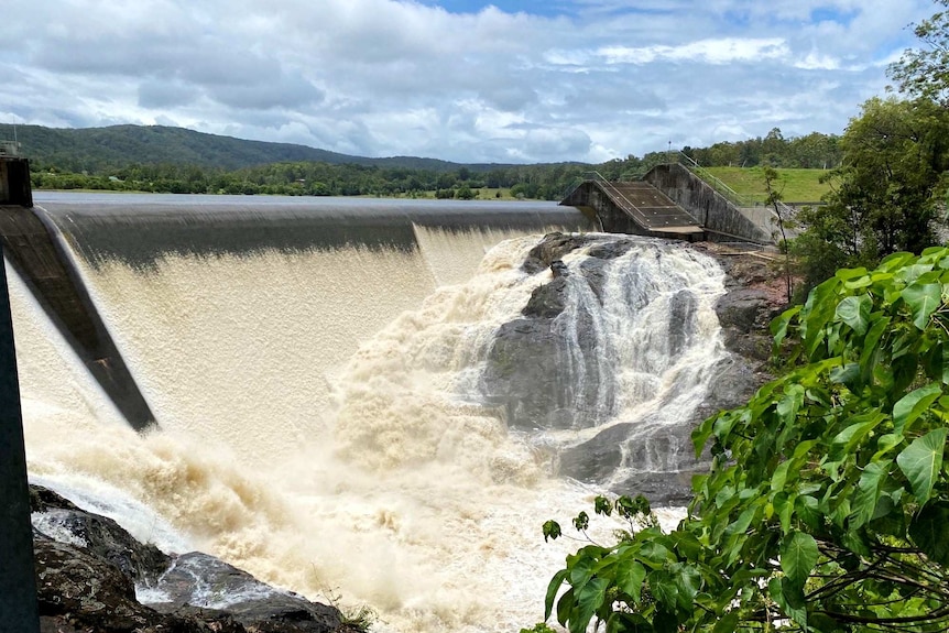 Dam overflowing with water.