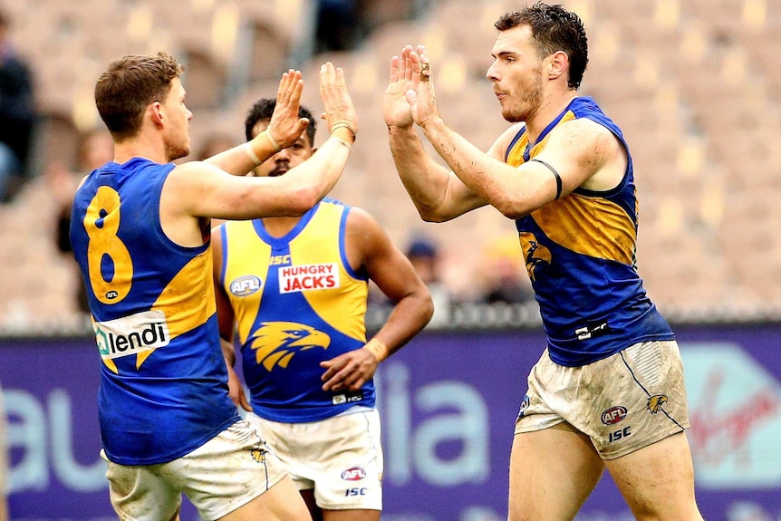 AFL team celebrations after a goal is scored.