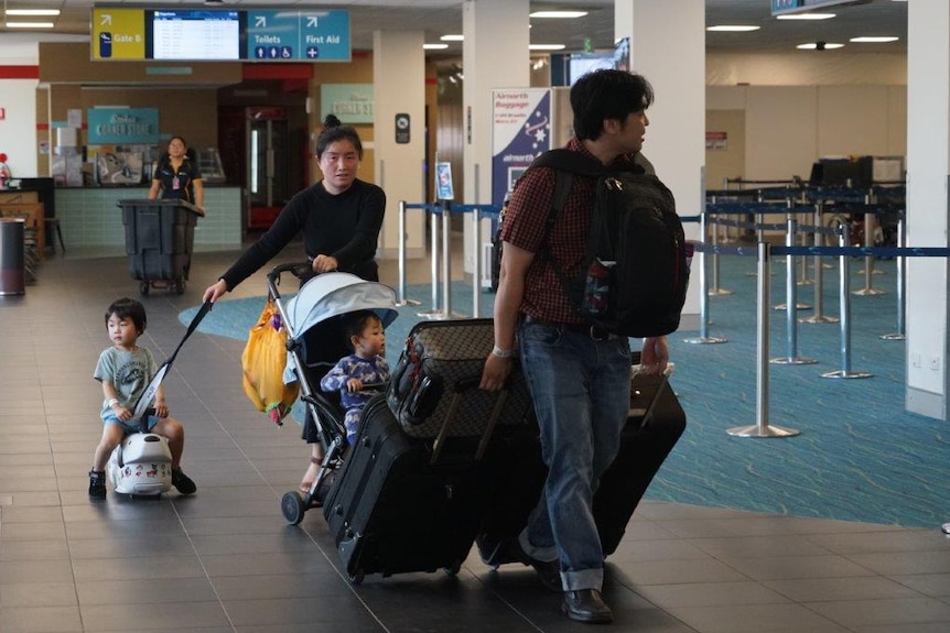 Australians evacuated from Wuhan head home from Darwin airport after their quarantine.