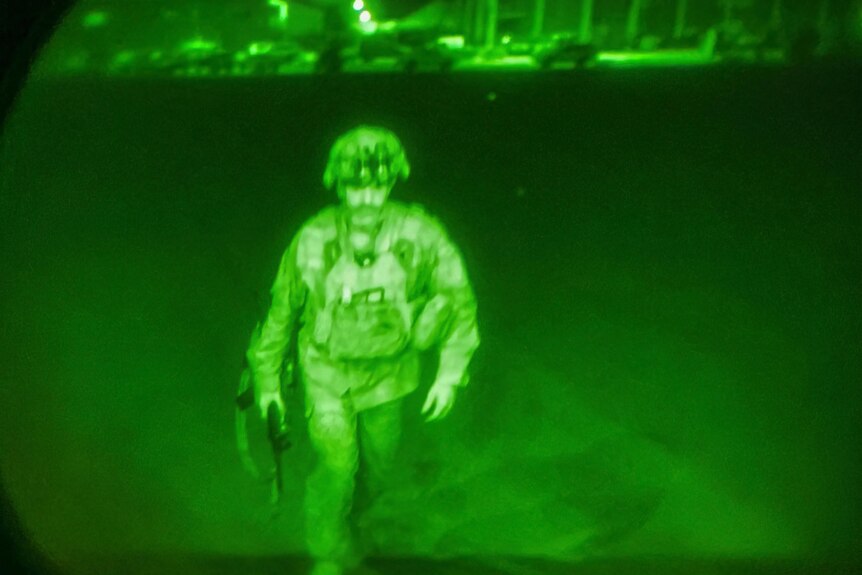 A US soldier seen through a night sight. 