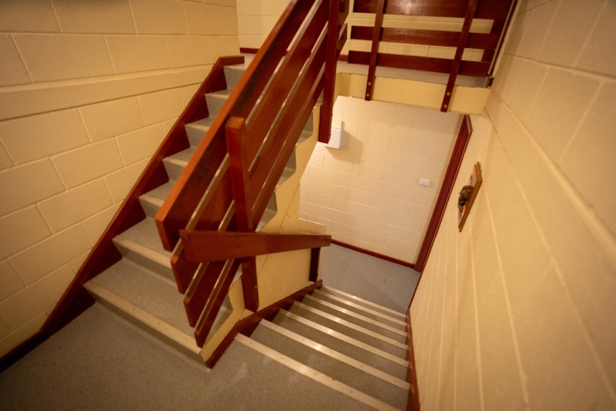 An indoor staircase, six steps then a landing then seven steps