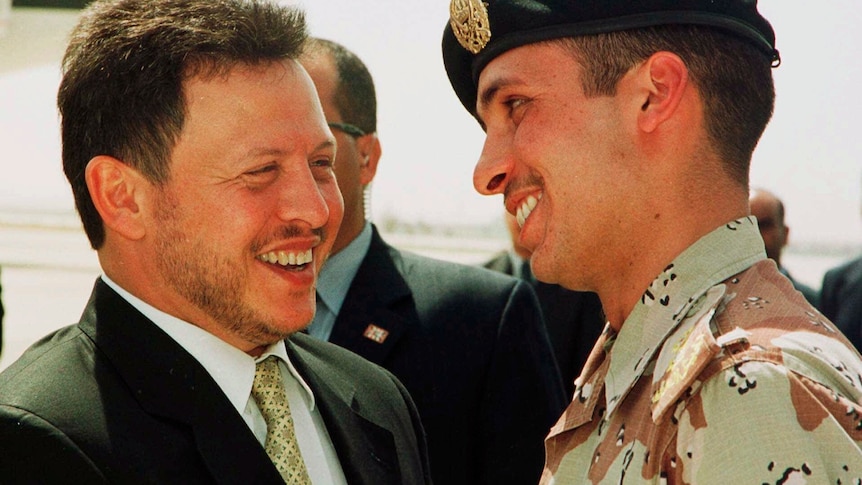 A file photo shows Jordan’s King Abdullah II laughing with his younger half brother Prince Hamza.