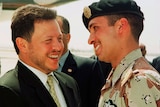 A file photo shows Jordan’s King Abdullah II laughing with his younger half brother Prince Hamza.