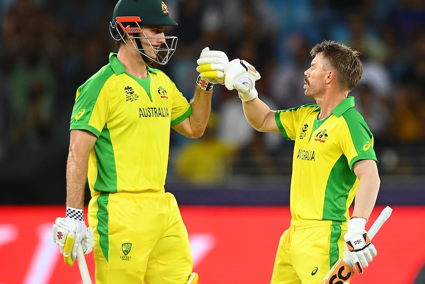 Mitchell Marsh and David Warner bump fists.