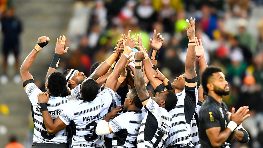 A group of rugby players celebrate victory in a final