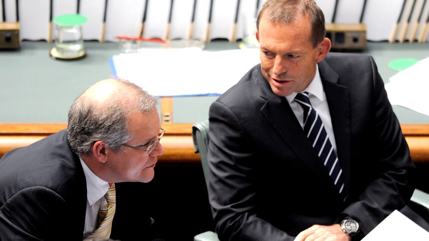 Opposition leader Tony Abbott listens to shadow immigration minister Scott Morrison question time
