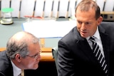 Opposition leader Tony Abbott listens to shadow immigration minister Scott Morrison question time