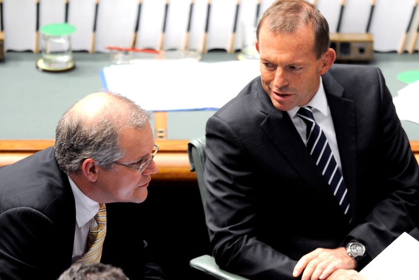 Opposition leader Tony Abbott listens to shadow immigration minister Scott Morrison question time