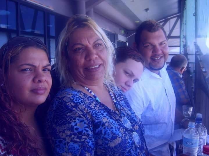 A family photo shows a young woman (Zak's sister), middle-aged woman (his mother), and two young men (Zak and his brother).