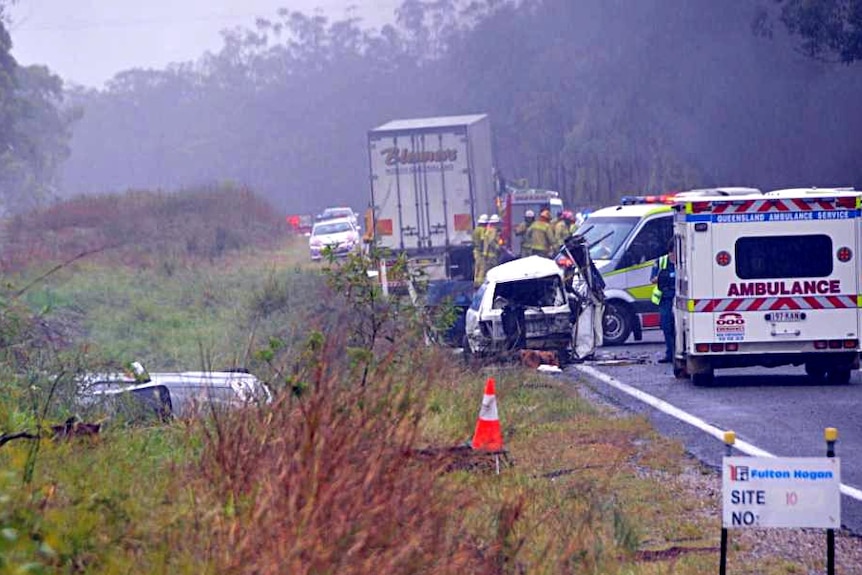Emergency crews gather at the scene of an accident on the Bruce Highway at Mt Larcom.