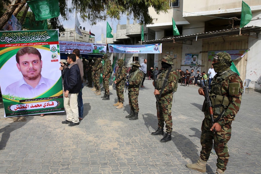 Hamas soldiers stand guard outside mourning tent for Fadi al-Batsh
