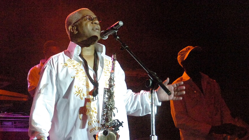 a man looking up while performing on stage