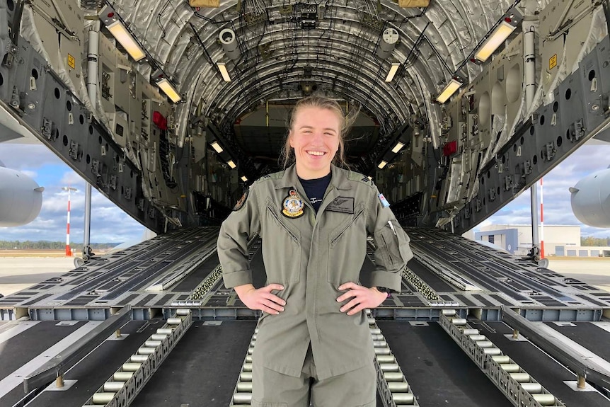 Brisbane Lions player Maria Maloney poses with a C-17 Globemaster in arm gear.