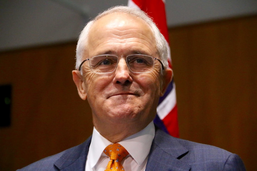 Prime Minister Malcolm Turnbull speaks at a podium inside Parliament House