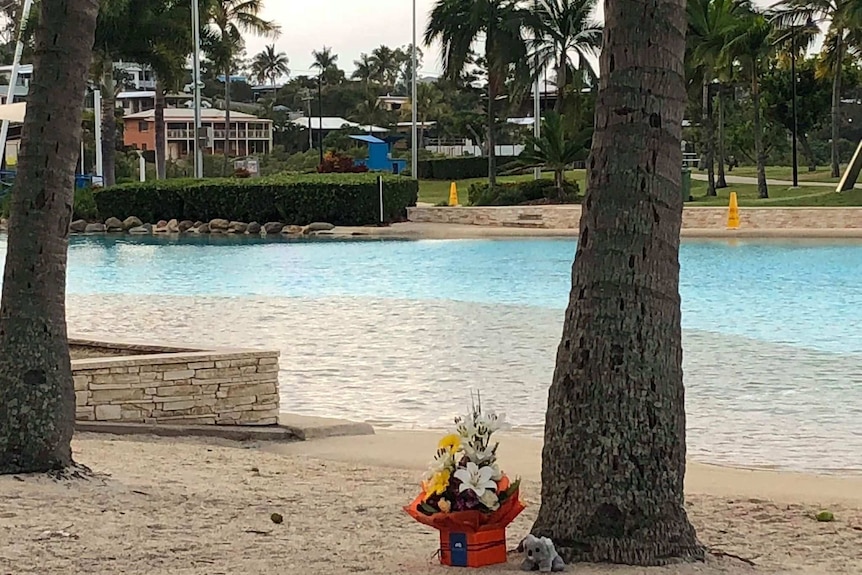 Flowers laid on the sand at the Airlie Beach Lagoon.
