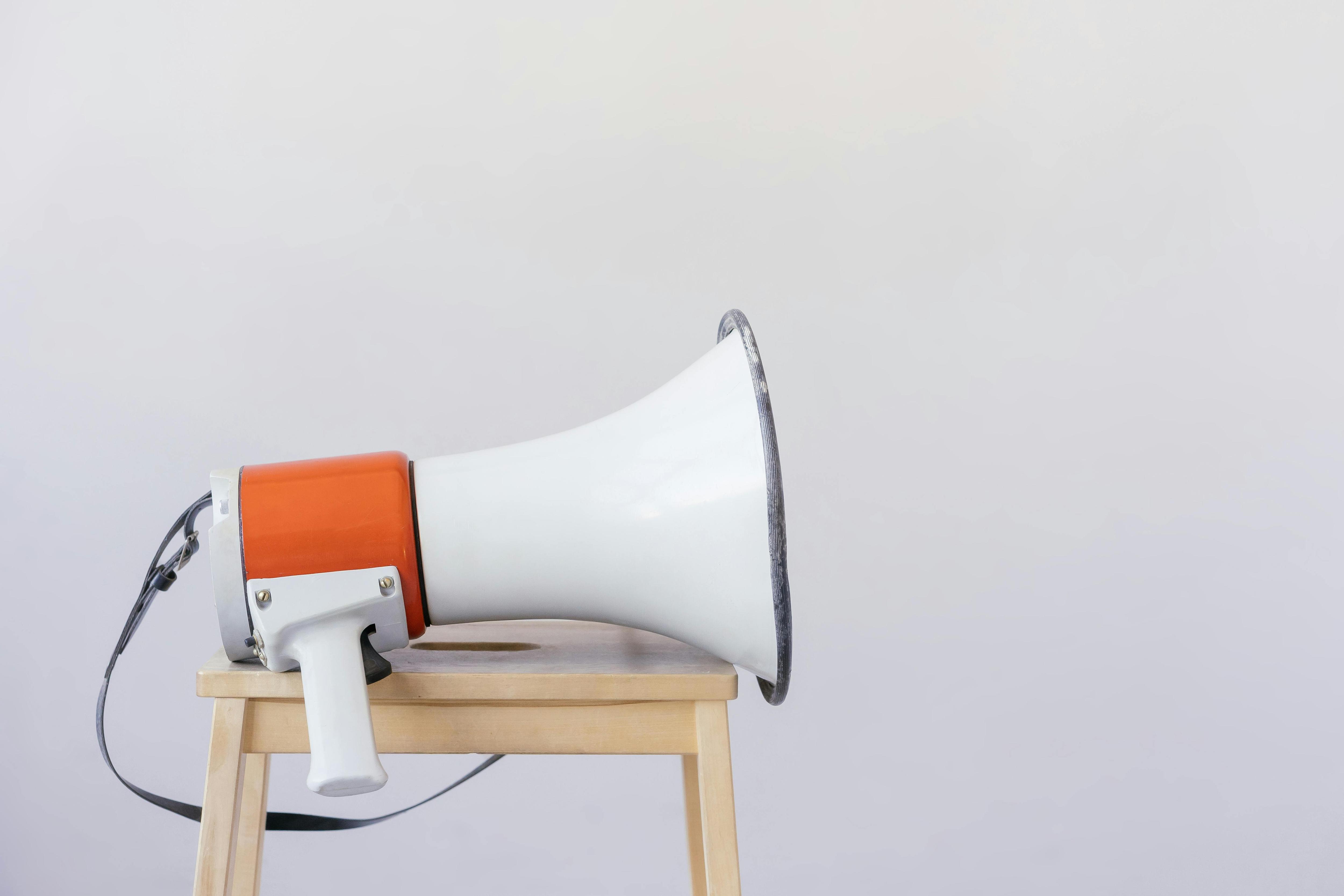Image of a megaphone on a wooden stool.