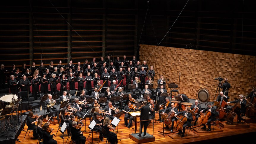 The Tasmanian Symphony Orchestra in front of the Tasmanian Symphony Orchestra Chorus in performance    