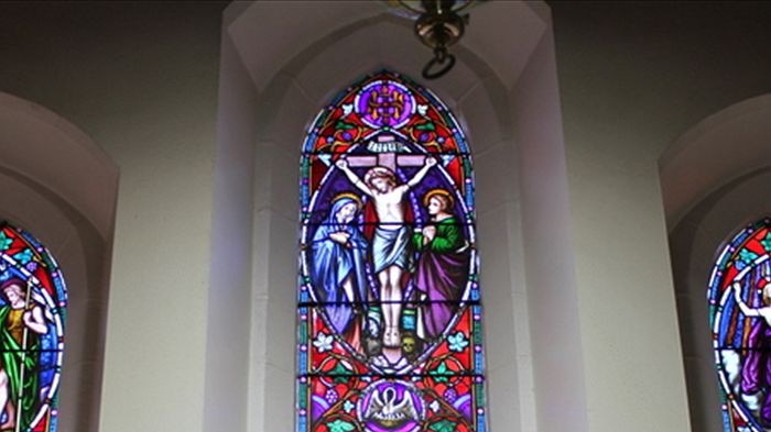 Stained glass windows above an altar (Jeremy Lee: ABC Local Radio)