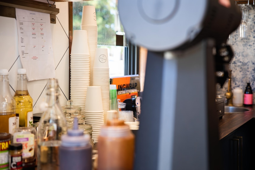 A stack of takeaway coffee cups at a cafe.