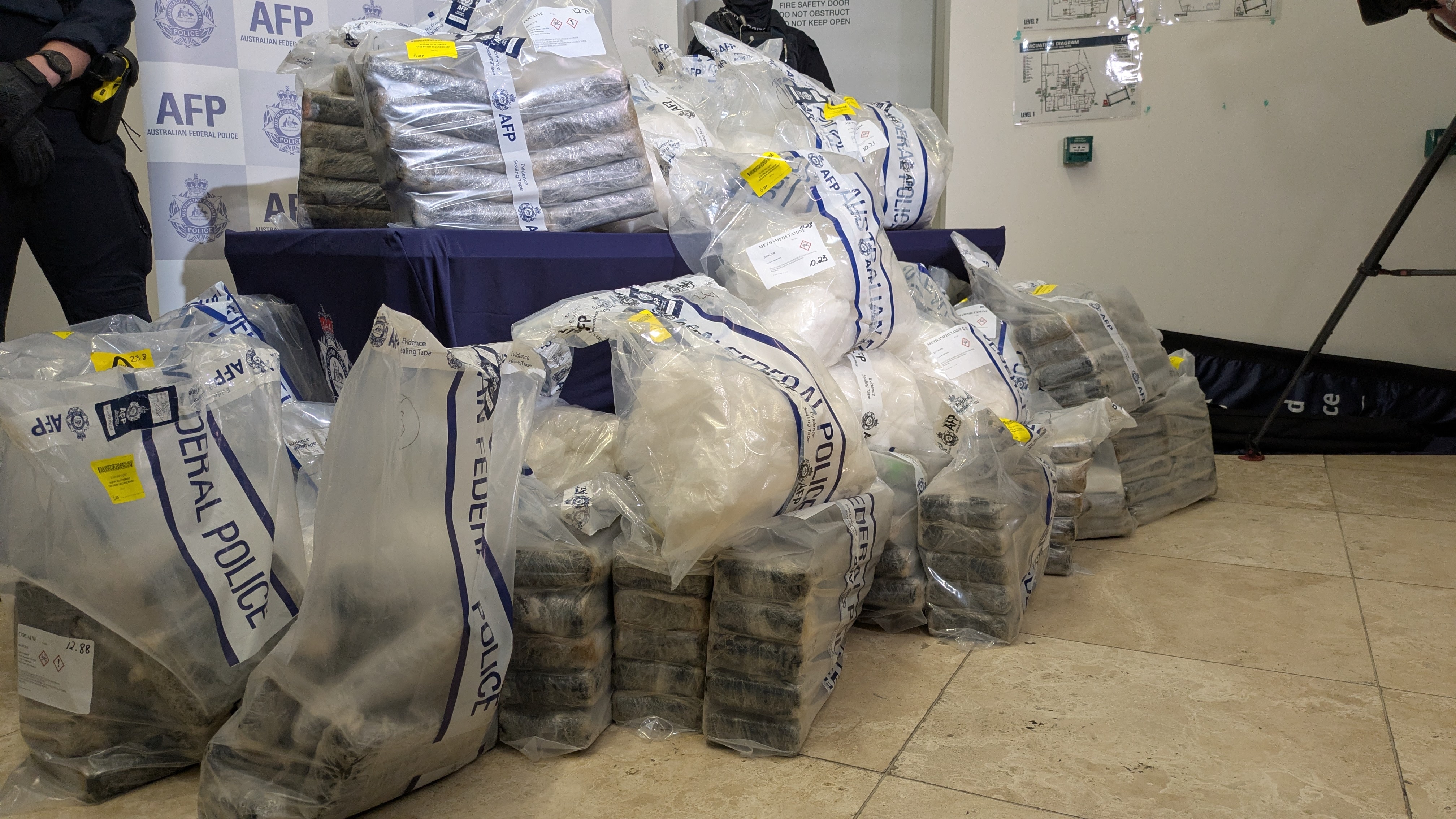 Piles of evidence bags full of drugs. 
