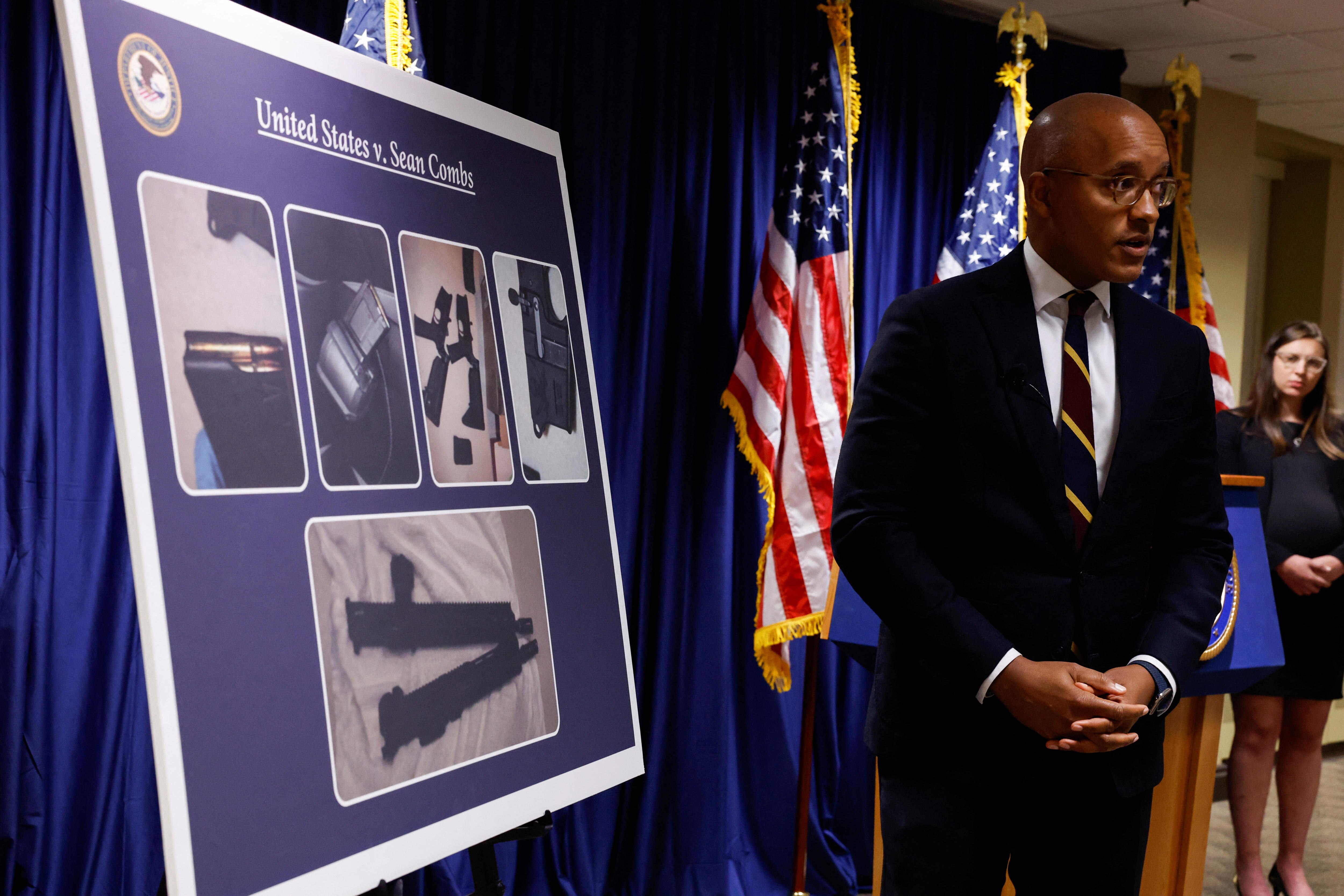 US Attorney Damian Williams stands next to a chart showing some of the items seized from Mr Combs' properties.