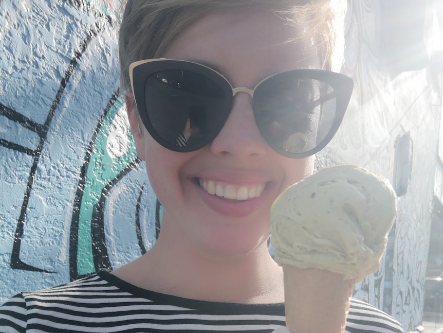 Ursula smiles with an ice-cream in the sunshine.