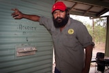 Aboriginal Man next to honesty box