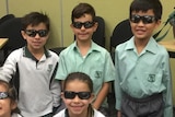 Students pose with sunglasses in the classroom
