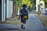 An anonymous primary school child walking to school in Brisbane.