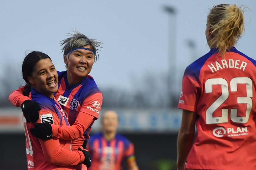 Sam Kerr is hugged by Ji So-yun.