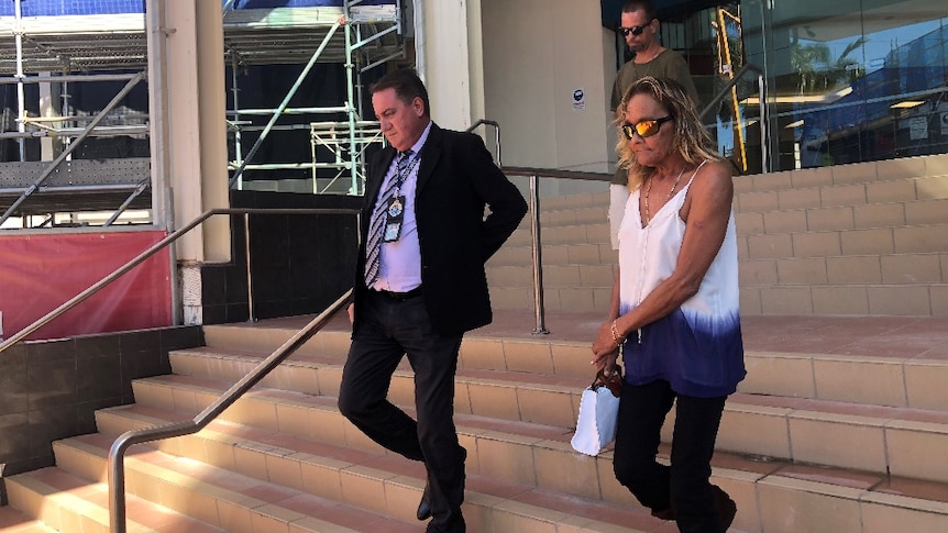 Detective Acting Inspector Paul Elliot leaves the Rockhampton court house with Tanya Dodd.
