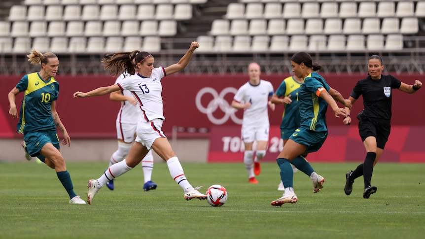 USA striker Alex Morgan dribbles towards Matildas captain Sam Kerr. 