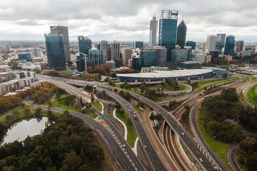A freeway interchange leading to Perth city in the background