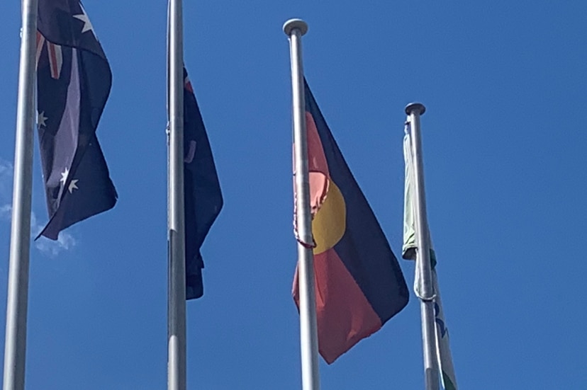 Four flags on flagpoles