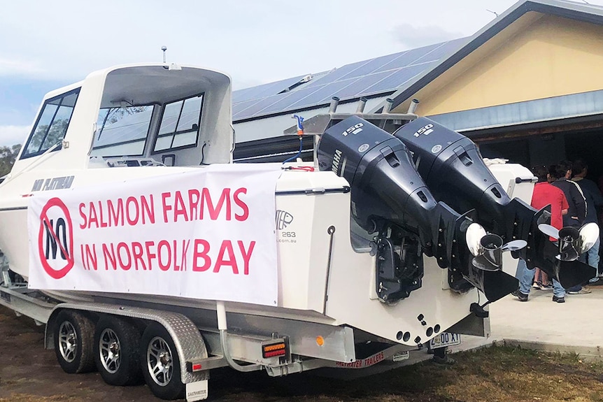 No Salmon Farms banner on boat at Dodge's Ferry community meeting, August 26, 2018.